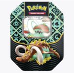 The Pokemon Paldean Fates Great Tusk Tin showcases the character Great Tusk. The tin is adorned with a decorative black and teal pattern, featuring the Pokémon logo at the top, and prominently displays Great Tusk, characterized by its green and brown design with tusks, on the packaging.