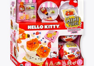 A packaged MGA's Miniverse Make It Mini Food Hello Kitty Series 1 toy set. The box showcases images of miniature food items like waffles with syrup and fruits, with predominantly red packaging that highlights the Hello Kitty branding.