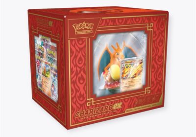 The Pokemon - Charizard ex Super Premium Collection includes a Charizard figurine, multiple trading cards, and features a red and gold design with Pokémon branding.